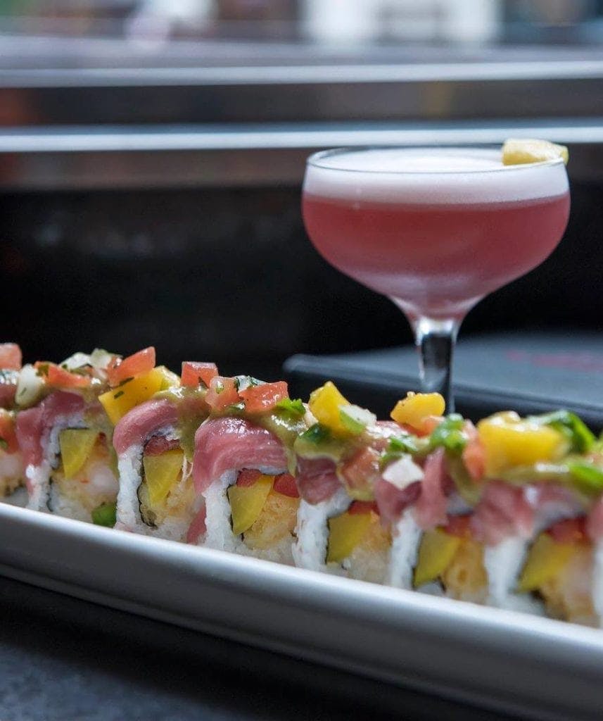 picture of Japonessa sushi roll with a cocktail drink at the bar for happy hour 